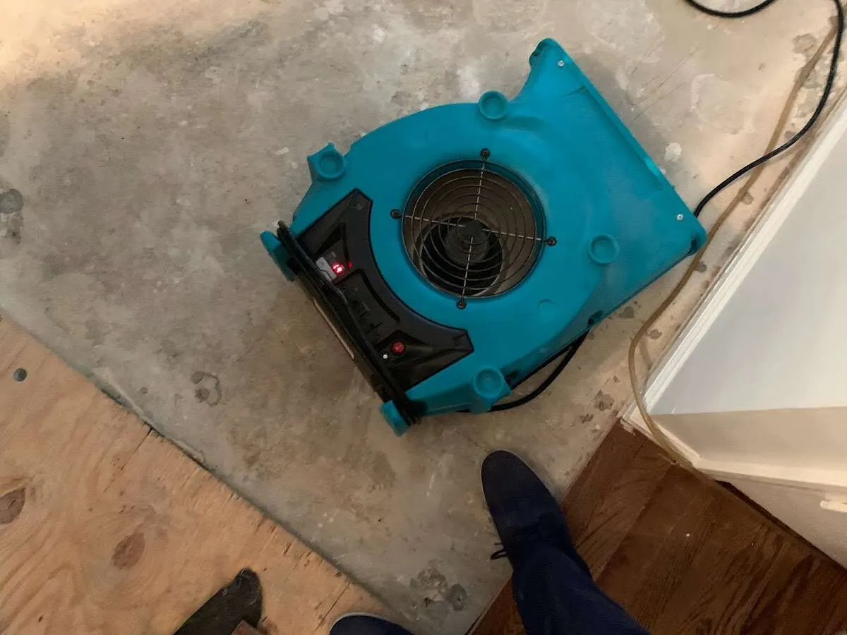 Air mover drying subfloor during Leak Detection & Repair in Lemay